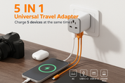 5-in-1 universal travel adapter charging multiple devices on a wooden surface.