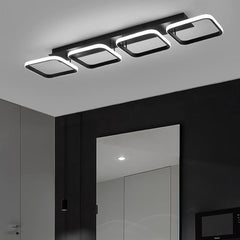 Modern ceiling light fixture in a room with a mirror and door.