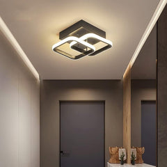Modern ceiling light fixture in a room with neutral walls and decor.