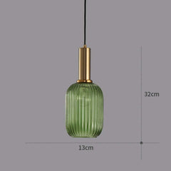 Green glass pendant light with gold fixture on a gray background