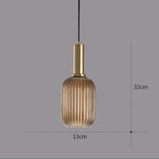 Pendant light with ribbed glass shade and gold fixture on a gray background