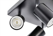 Black ceiling light fixture with two adjustable lights on a white background