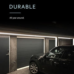 Garage with a car parked in front of a closed garage door, with text 'Durable All-year around' on a black background.