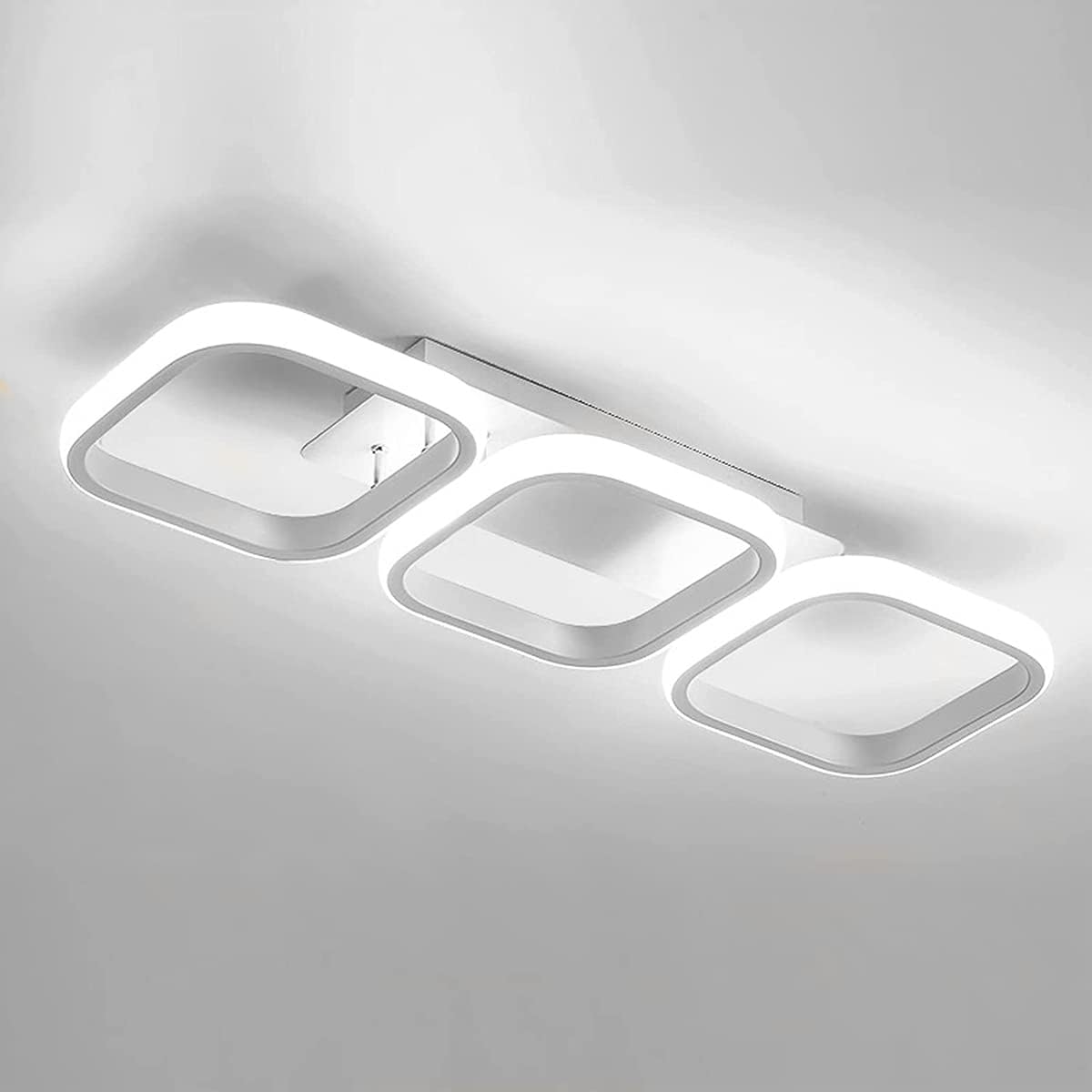 Modern ceiling light fixture with three rectangular panels on a gray background