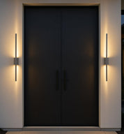 Modern black door with wall lights on a neutral background