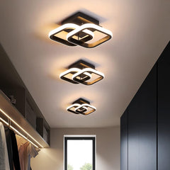 Modern ceiling lights in a room with neutral walls and a window.