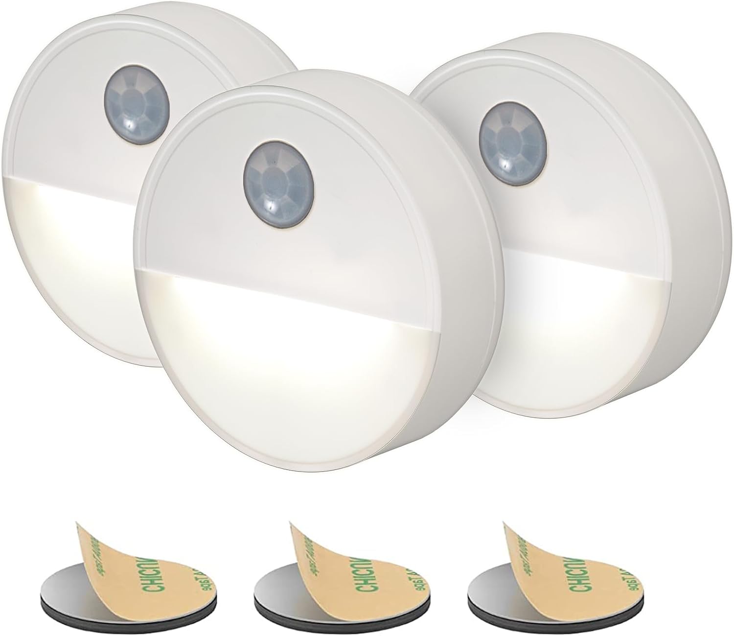 Three motion sensor lights with adhesive pads on a white background