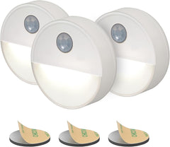 Three motion sensor lights with adhesive pads on a white background