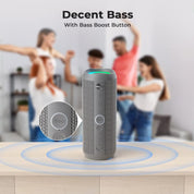 Gray speaker with Bass Boost Button on a wooden surface, people dancing in the background.