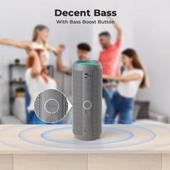 Gray speaker with Bass Boost Button on a wooden surface, people dancing in the background.