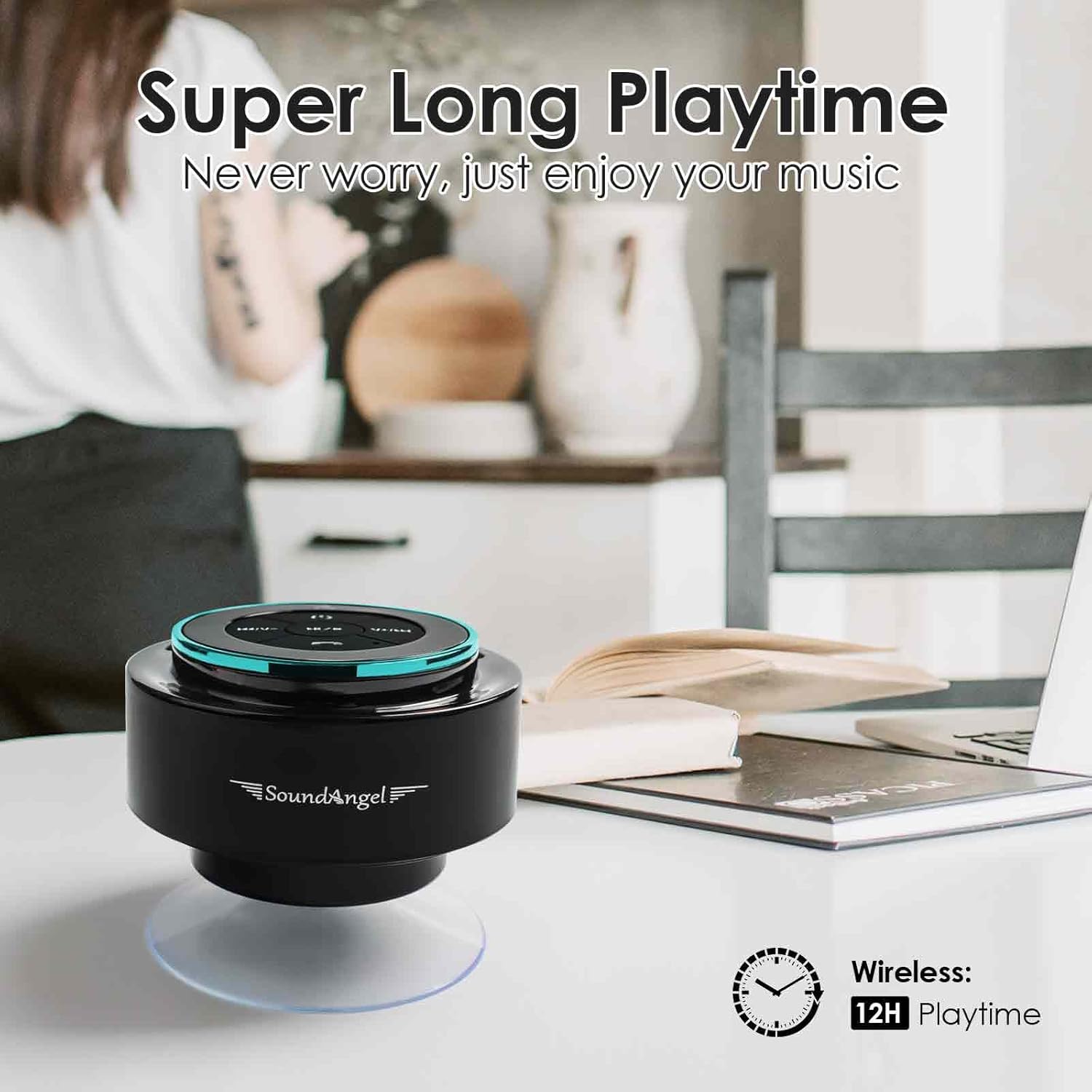 Black and teal SoundAngel speaker on a table with a person in the background