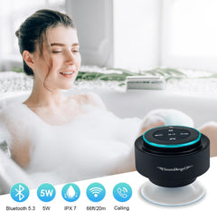 Woman in a bathtub with bubbles, holding a black Bluetooth speaker labeled 'SoundAngel'.