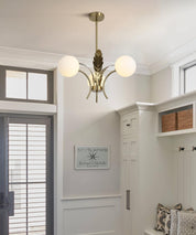 Modern chandelier in a room with white walls and a door.