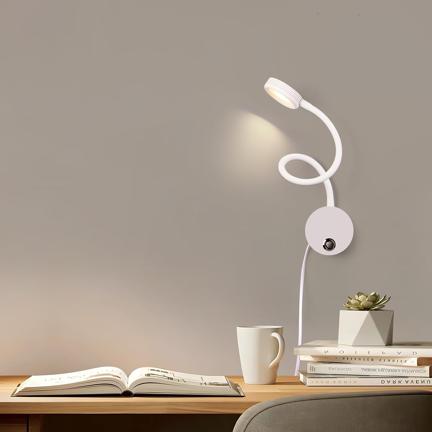White LED desk lamp on a wooden surface with books, a mug, and a plant.