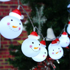String lights shaped like snowmen with red hats on a Christmas tree.