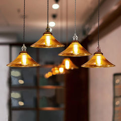 Gold pendant lights hanging in a room with blurred background