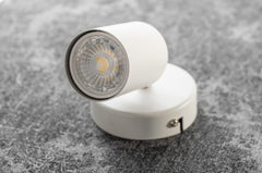 White spotlight on a textured gray surface