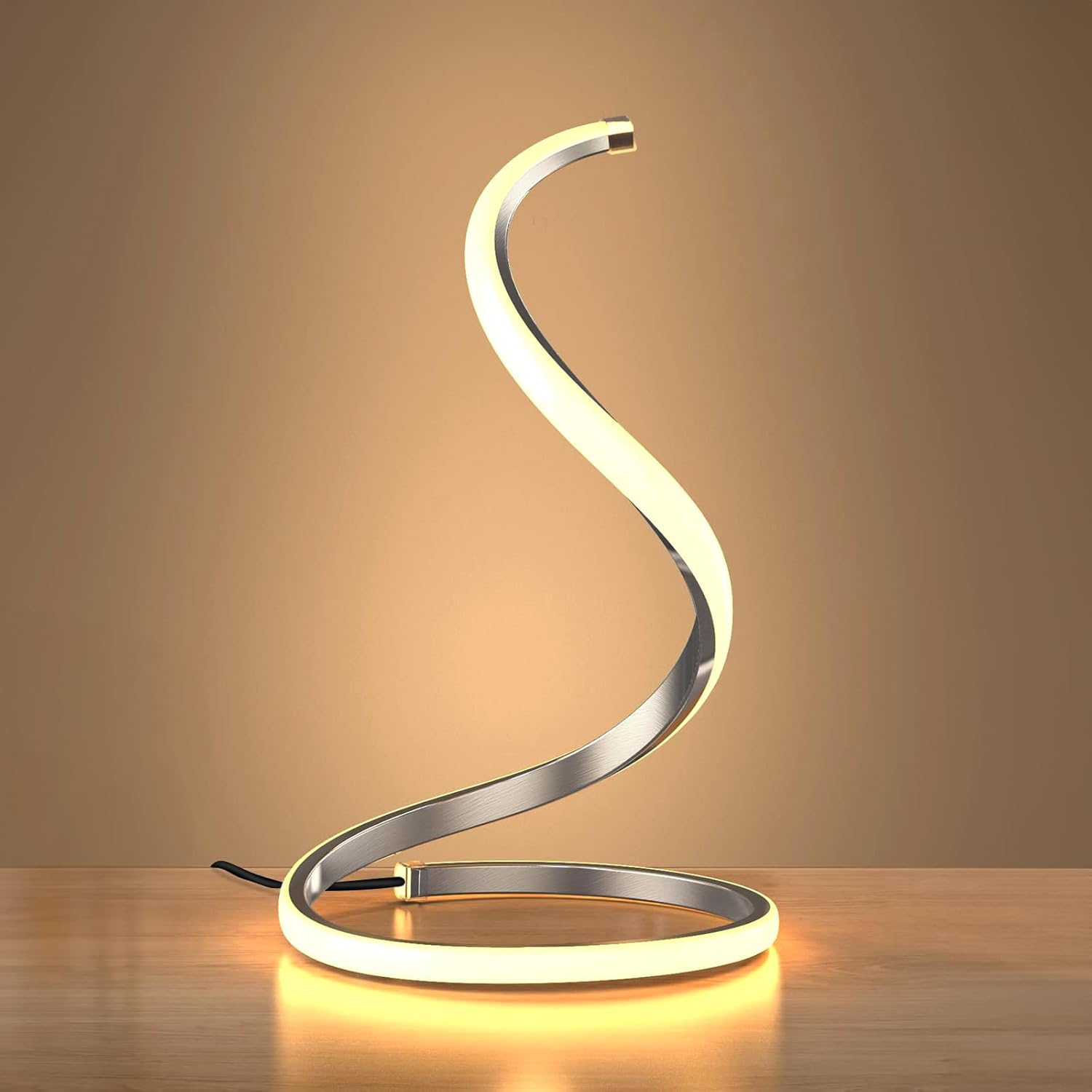 Modern table lamp with a curved design on a wooden surface.