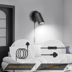 Wall-mounted black light fixture with power cord and on/off switch in a living room setting.