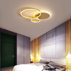Modern bedroom with a ceiling light fixture and gray wall.