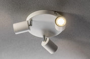 White ceiling light fixture with two adjustable arms on a gray ceiling.