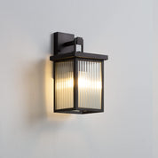 Modern outdoor wall light fixture on a gray background