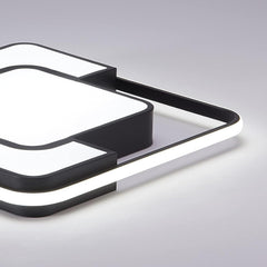 Modern black and white light fixture on a gray background