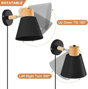 Wall-mounted lamp with black shade and wooden accent, showing rotation and tilt features on a white background.