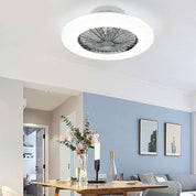 Ceiling light fixture in a modern living room with a table and decor items.