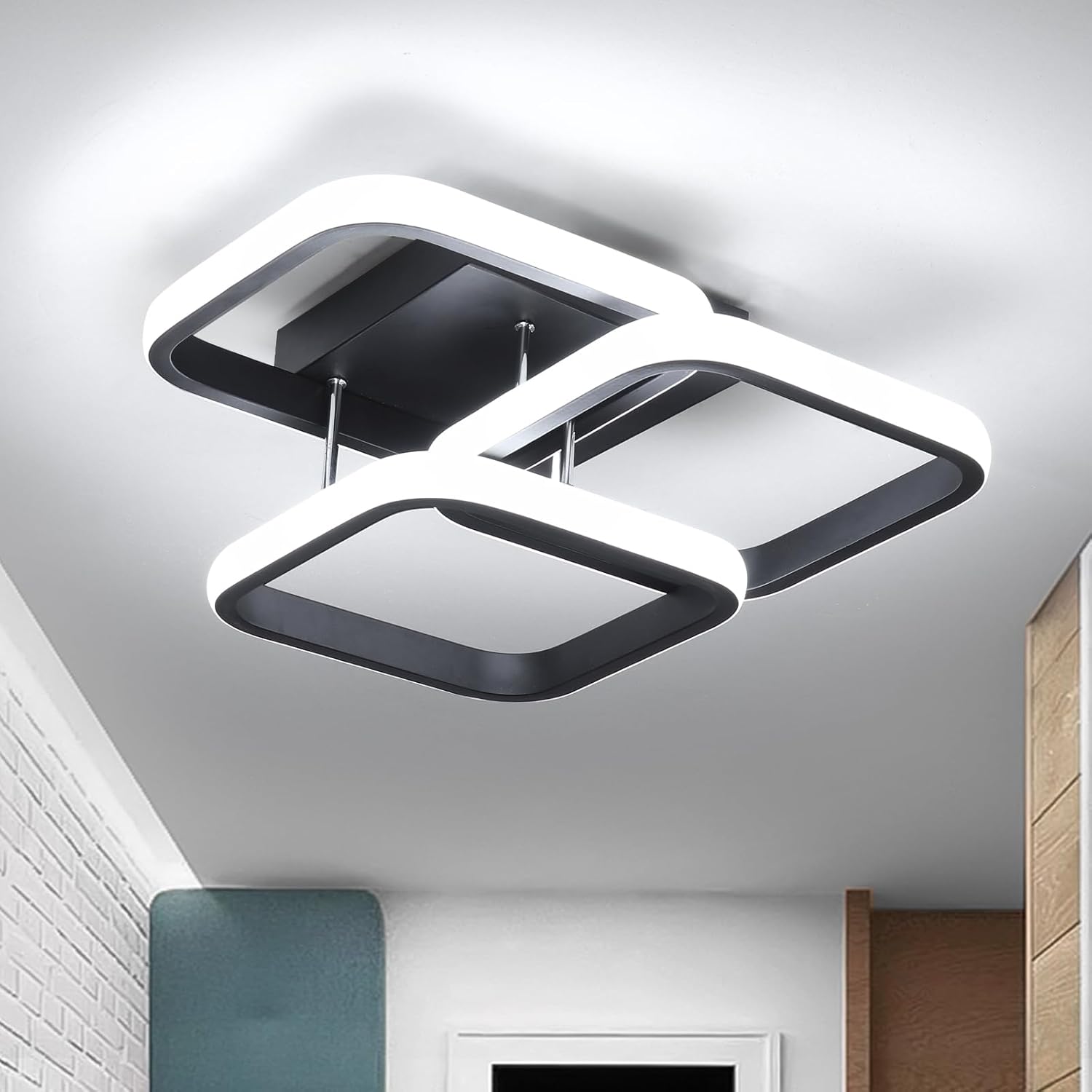 Modern ceiling light fixture in a room with white walls and wooden elements.