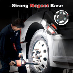 Person working on a tire with a tool, emphasizing a strong magnet base feature.