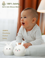 Baby holding two white rabbit-shaped night lights with safety text above