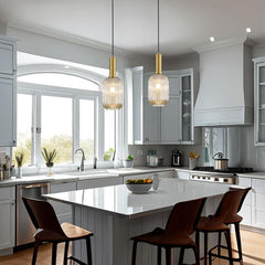 Modern kitchen with white island, pendant lights, and large windows.