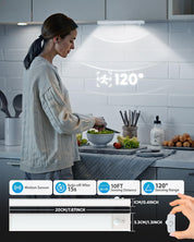 Woman preparing food in a kitchen with a motion sensor light above her head.