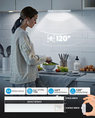 Woman preparing food in a kitchen with a motion sensor light above her head.