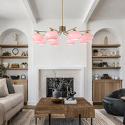 Modern living room with pink ceiling lights, wooden coffee table, and decorative shelves.