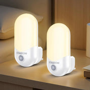 Two Stanbow night lights on a wooden surface with a blurred background