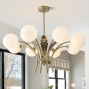 Modern chandelier with gold finish and white glass shades in a room setting.