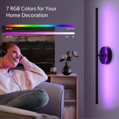 Woman watching TV with a wall-mounted LED light displaying RGB colors on a gray wall.