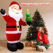 Garden decorated with inflatable Santa Christmas lights