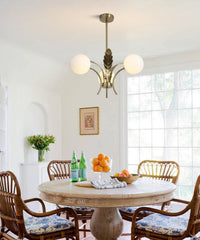 Dining room with wooden table and chairs, chandelier, and large window.