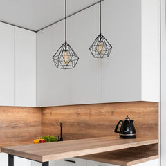 Modern kitchen with wooden countertop, black kettle, and geometric pendant lights.
