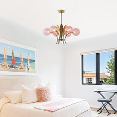 Modern living room with a chandelier, sofa, and wall art.