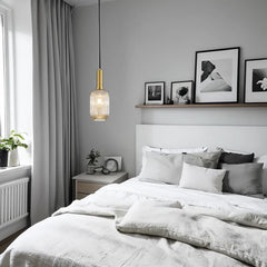 Modern bedroom with a bed, nightstand, and wall art.