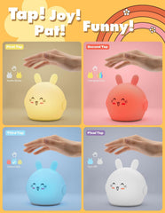 Four different colored rabbit-shaped night lights with taps on a colorful background