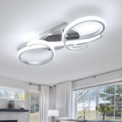 Modern ceiling light fixture in a living room with large windows