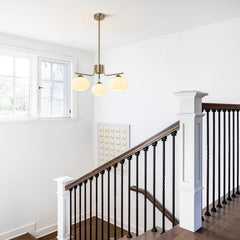 Staircase with a modern chandelier in a well-lit room