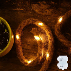 Coiled rope with embedded lights on a rustic wooden surface
