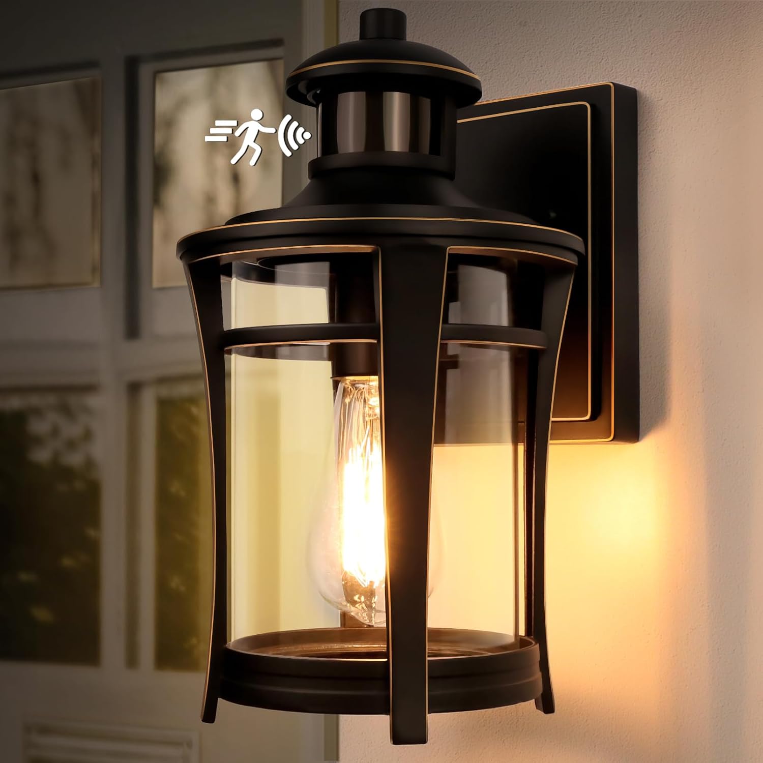 Wall-mounted outdoor light fixture with a warm glow, featuring a clear glass cover.