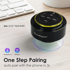 Black Bluetooth speaker with SoundAngel branding on a desk with keyboard and mug